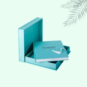 A stylish teal mailer boxes showcasing an elegant book inside, ideal for a sophisticated gift or personal collection.