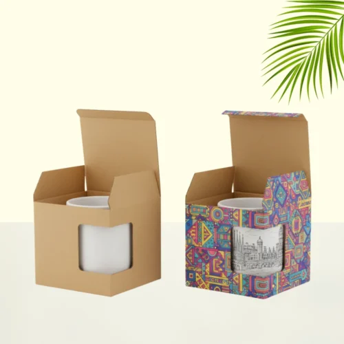 Two custom mug boxes shown side by side. The one on the left is plain brown kraft, and the one on the right is printed with a colorful, abstract pattern. Both boxes have a cut-out window to display the mug inside.