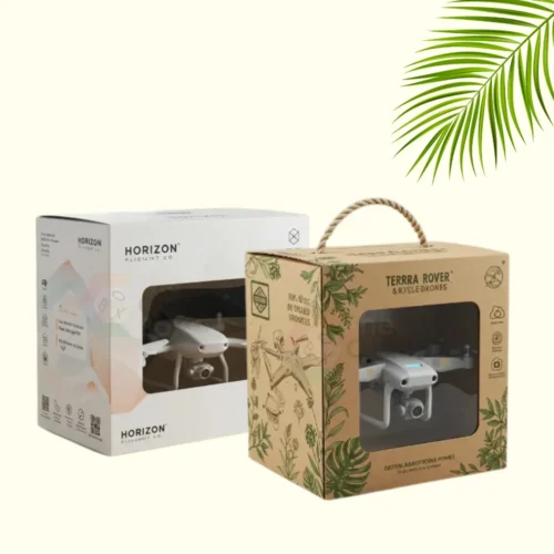 Two drone packaging boxes side by side. The one on the left is white with a "Horizon Flight Co." logo, and the one on the right is a brown kraft box with a "Terra Rover" logo and a rope handle. Both boxes have a clear window displaying a drone inside.