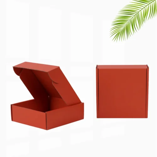 An open Red Mailer Boxes with a red interior and dividers next to a closed, plain cardboard box.