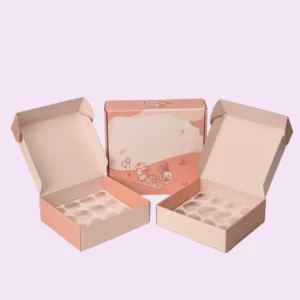 Pink custom cookie mailer boxes, shown open with a heart-shaped insert, and a matching closed box in the center, suitable for Valentine's Day or bakery packaging.