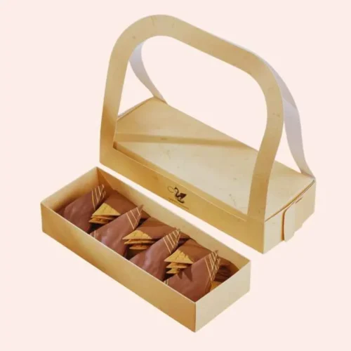 Elegant cookie mailer box with a transparent lid and handle, showcasing triangular chocolate cookies inside, perfect for luxury gift packaging.