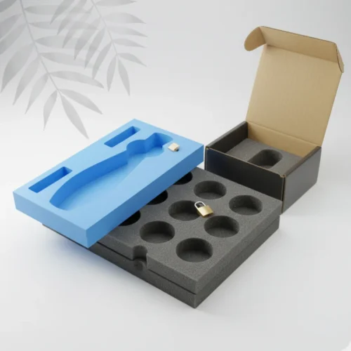Custom-molded polyurethane packaging foam inserts, white, cut to perfectly cushion and secure a fragile electronic device inside its retail box.