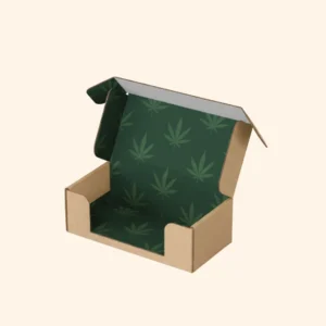 Open brown kraft cardboard shipping box with a deep green interior base and lid lining patterned with dark green cannabis leaves, designed for product protection.