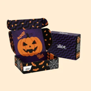 A 3D mockup of a custom-printed Halloween Boxes. The inside features a purple design with an orange pumpkin, the words "BOO!" and "HAPPY HALLOWEEN", while the outside has a striking black and purple zigzag pattern.