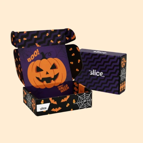 A 3D mockup of a custom-printed Halloween Boxes. The inside features a purple design with an orange pumpkin, the words "BOO!" and "HAPPY HALLOWEEN", while the outside has a striking black and purple zigzag pattern.